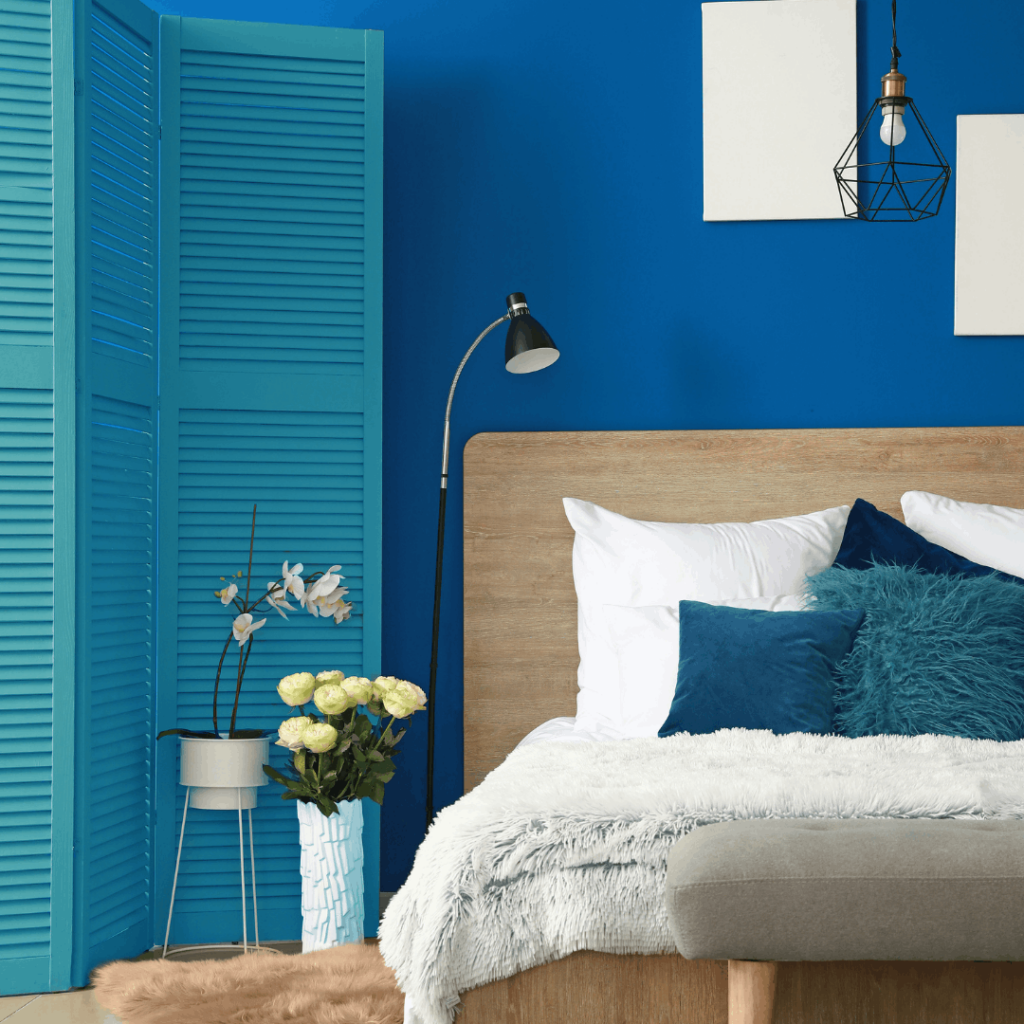 modern bedroom with blue walls and a teal blue closet door