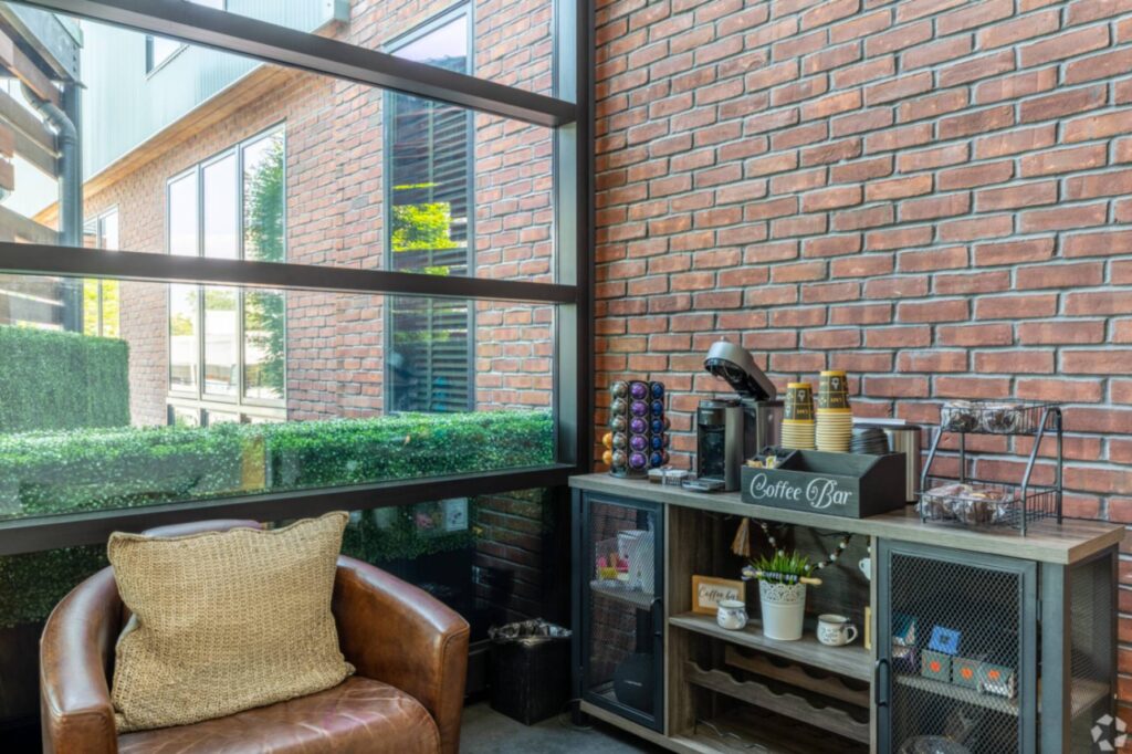 lobby coffee station next to an exposed brick wall