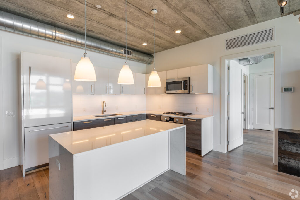 large open kitchen with white countertops and cabinets