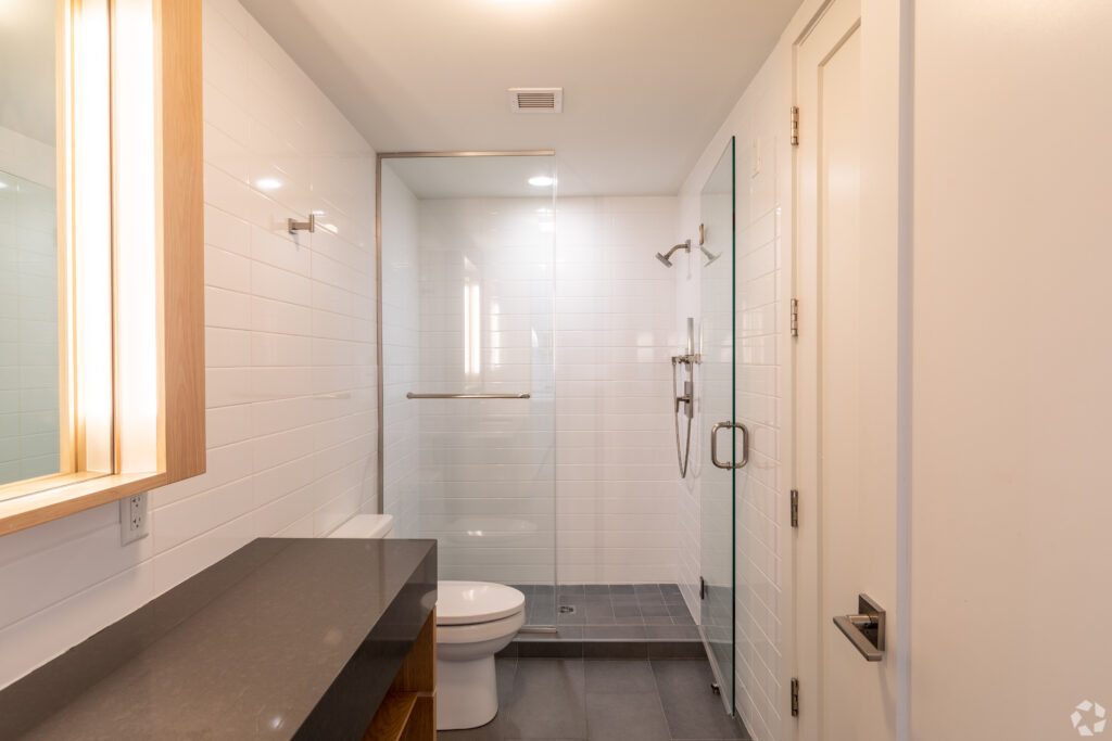 master bathroom with a glass enclosed shower with dark tile floors