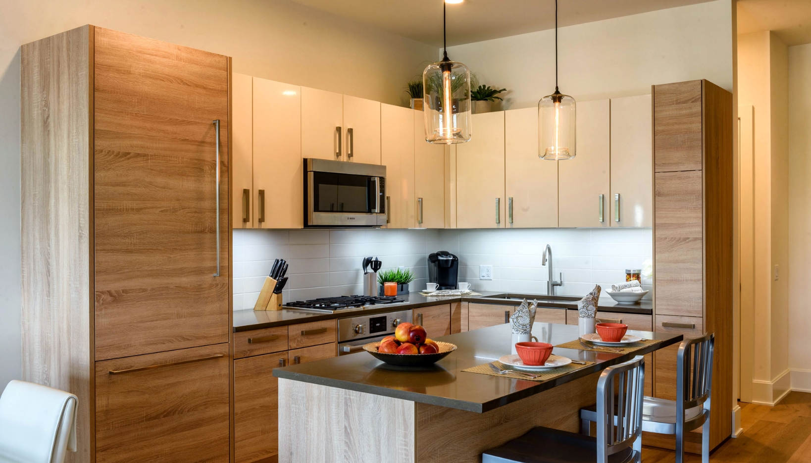 large kitchen with light brown cabinets and storage